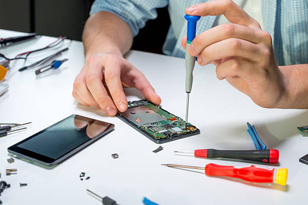 Technician repairing a mobile phone